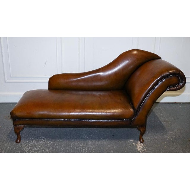 Exquisite Antique Restored Victorian Brown Leather Chaise Lounge Settee. Featuring a beautifully stripped-back leather...