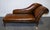 Exquisite Antique Restored Victorian Brown Leather Chaise Lounge Settee. Featuring a beautifully stripped-back leather...
