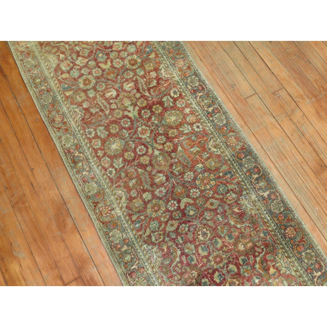 An early 20th Century traditional narrow Persian Kashan runner Measures: 2'3'' x 12'10''.