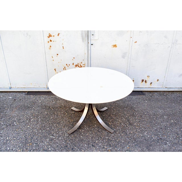 Dining table with metal and wood frame, round lacquered wood top. Model T69 Designed by Eugenio Gerli and Osvaldo Borsani...