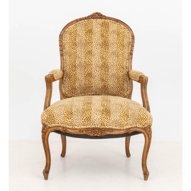 Louis XV Style Leopard Print Upholstered Walnut Fauteuil, the cresting carved with floral rosettes. 39.5" H x 25.5" W x...