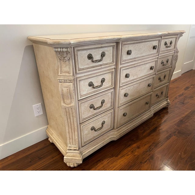 This beautiful dresser has a glazed look over and cream ivory. Beautiful carved. 12 Drawers. This item has have some aging...