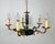 An elegant vintage chandelier with 5 arms in the empire style. the base is made of bronze and metal of green and gold...