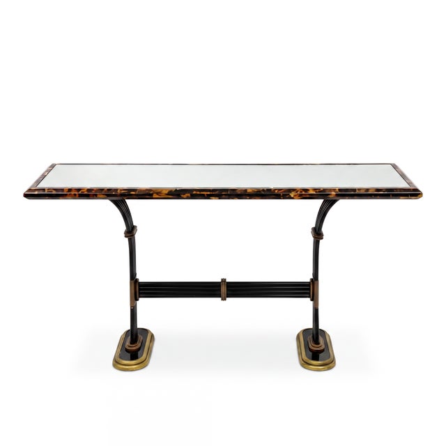 This is a Maitland-Smith neo-classical style mirrored console table with tessellated horn frame and cast bronze accents....