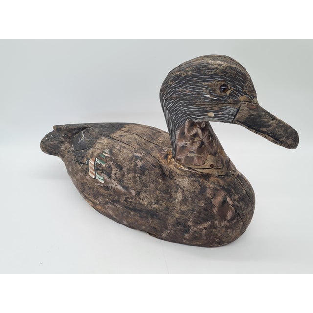 A unique, hand-carved wooden hunting decoy duck, most likely originating from Northern or Central Europe. The piece is...