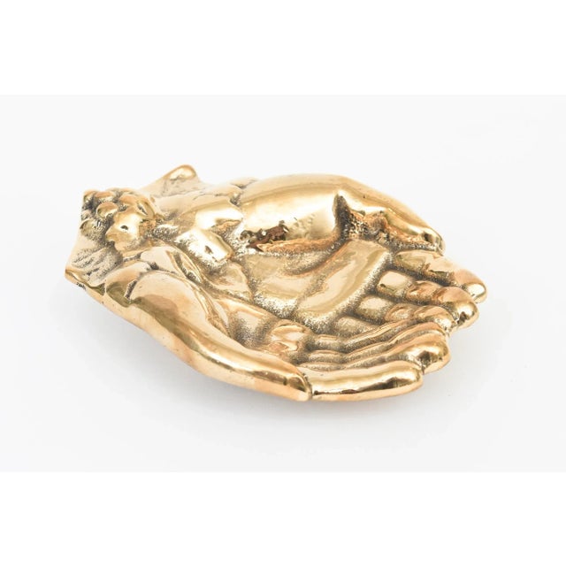 This vintage mid century modern cast bronze praying cupped hands bowl, paperweight or decorative object has now been newly...