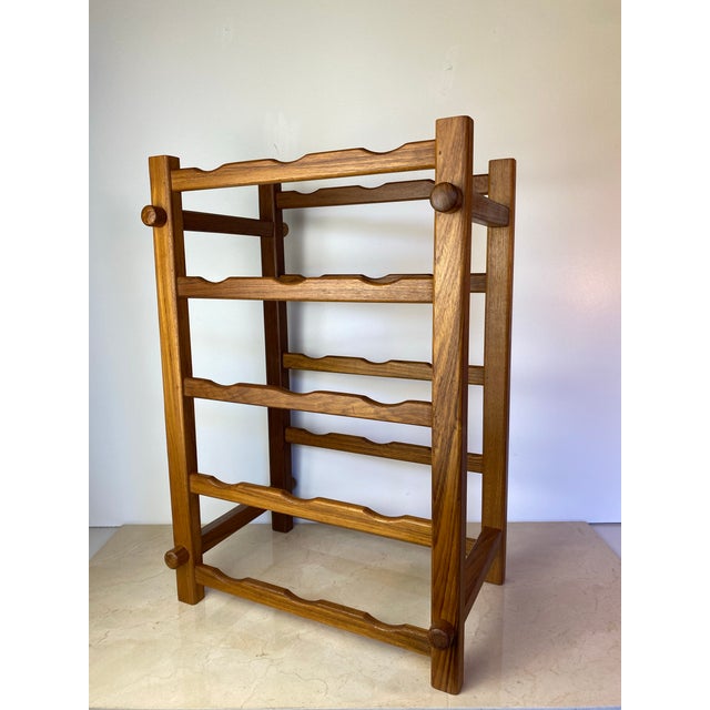 Substantial vintage wine rack in solid teak by Winsome Wood, featuring a tall, open ladder-style frame with five...