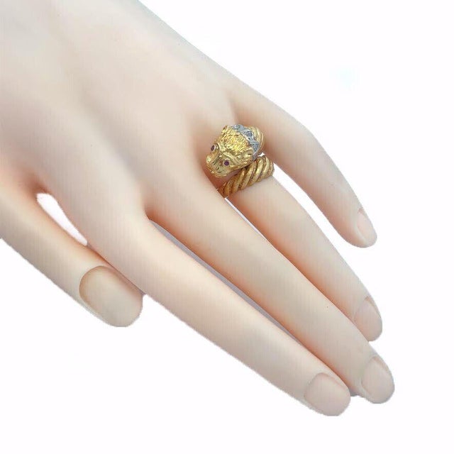 This is a Greek style lion head ring crafted from 18k yellow gold with a rose cut diamond collar around the lion's neck....