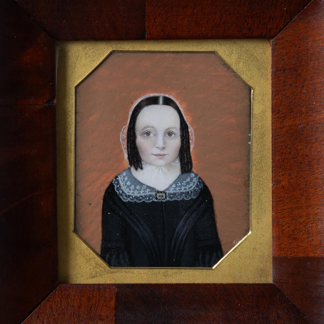 A portrait miniature of a young-faced woman identified as Elizabeth Adams, painted within a cut-corner rectangular format...