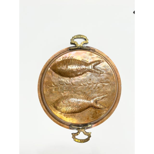 Wonderful vintage hammered copper fish mold pan with a rustic appeal for cooking or decor. Handles of brass accent this...