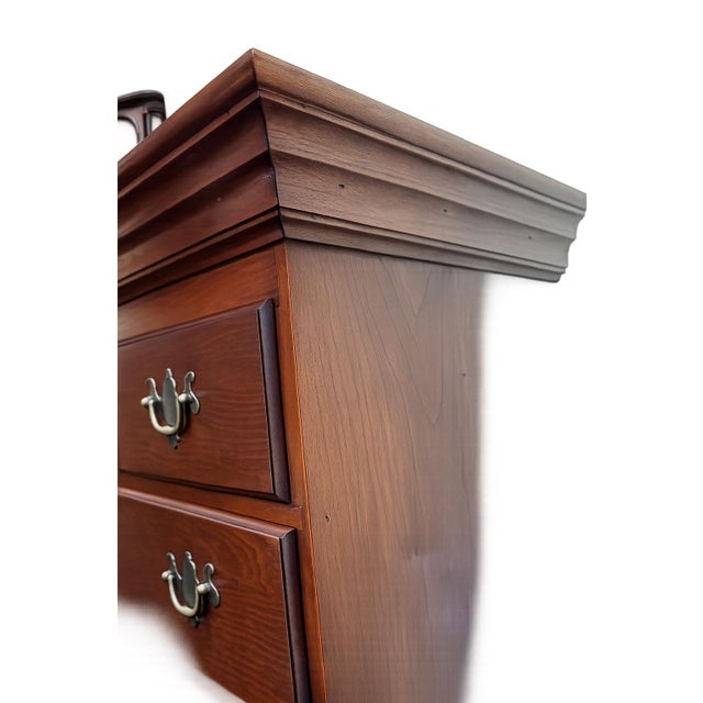 A beautifully handcrafted Queen Anne-style cherry chest on frame by renowned Massachusetts furniture maker Eldred Wheeler,...