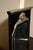 Art Deco wall mirror in black lacquer with white gold-leaf details. Ornate floral carving decorating top of mirror....