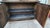 Ornate wooden display cabinet with a dark brown stained finish. This two-piece hutch has a top section with two glass-...