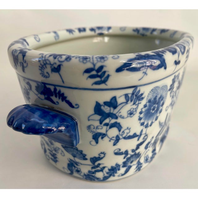 A delightful Chinese export style porcelain jardiniere with double handles flanking an oval form with thick form rim in...