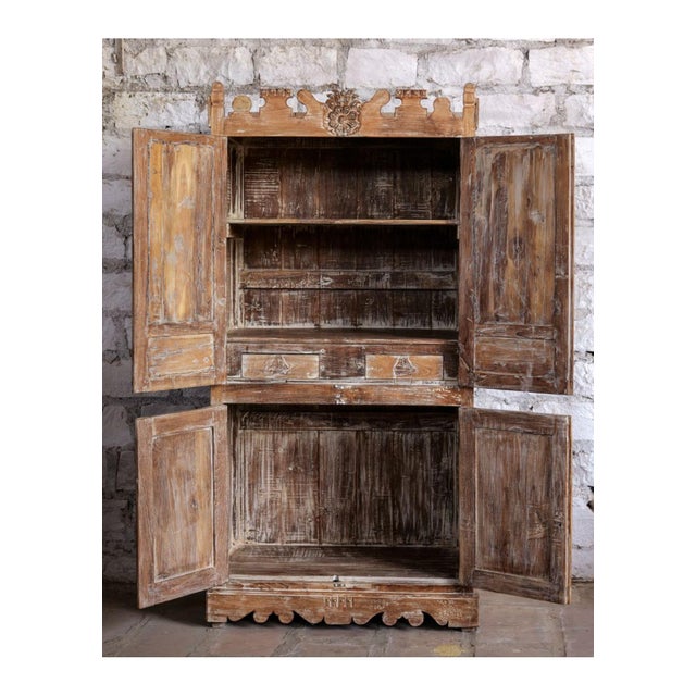 Elevate your space with this exquisite antique carved armoire cabinet, a true statement piece that blends artistry with...