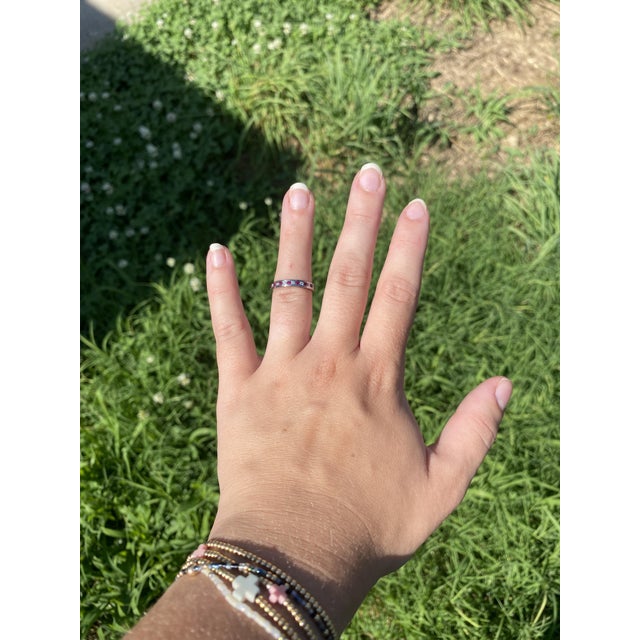 Stones: ruby, 5 round cut 2.25 mm approximately .25 total carats diamond, 6 round brilliant cut 2.25 mm approximately .36...