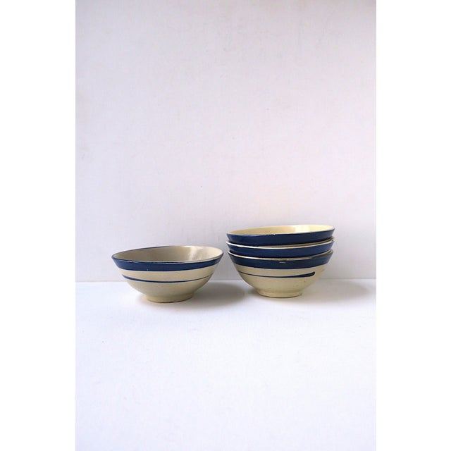 A set of four (4) hand-made small serving pottery bowls, in the Country/Rustic design style, circa late-20th century....