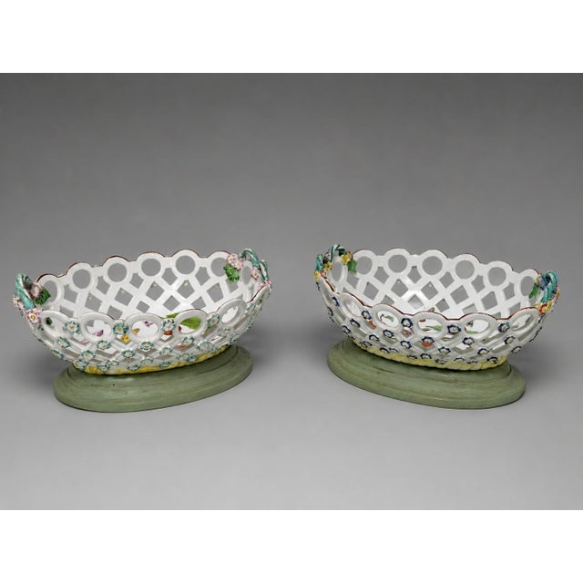 A fine pair of early English Derby porcelain reticulated oval baskets, circa 1758–1765, each finely pierced with circular...