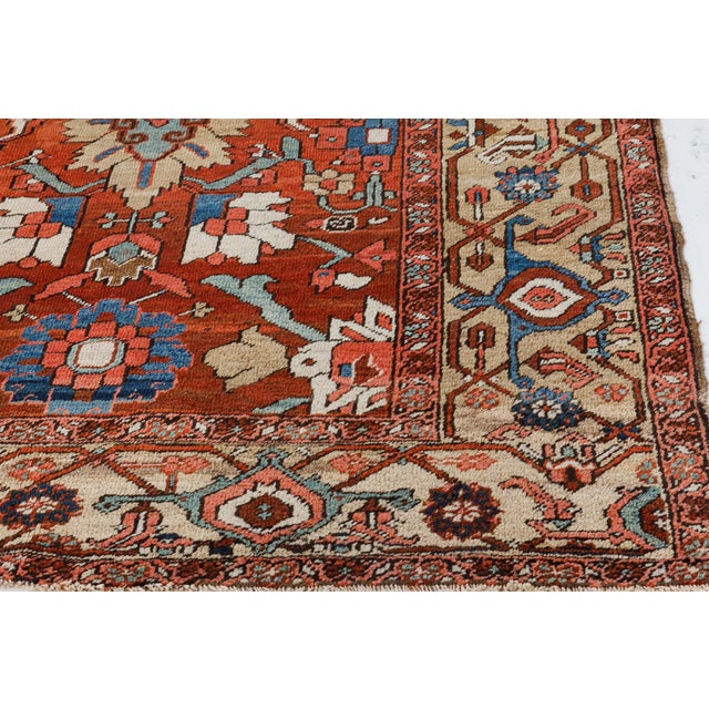 This antique, hand-knotted blue Persian rug is made out of wool and was made around 1920. Its color palette includes blue,...