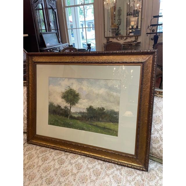 A large late 19th, early 20th century painting presented in a carved and patinated gold tone frame. This lovely landscape,...