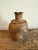 Antique Anatolian clay vessel with beautifully aged texture and organic form. This Turkish pottery piece features a warm...