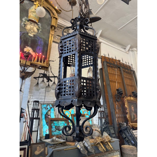This exquisite 1920s Spanish Revival pendant lantern is a rare architectural gem salvaged from a historic California...