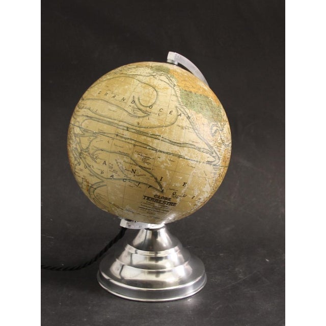 This art deco globe was made between 1920 and 1949 in France. It features a glass globe on a polished aluminium base and...