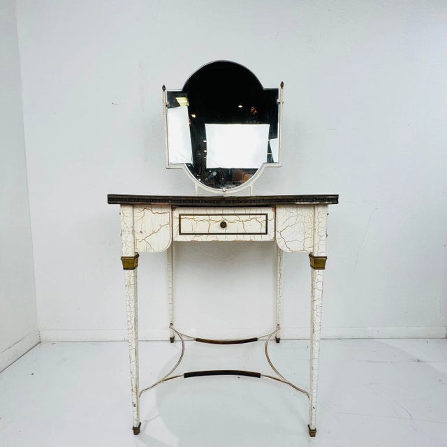 Stunning Louis XVI style dressing table/vanity. Featuring a double sided mirror and painted metal legs, this dressing...