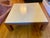 Striking square coffee table by Ralph Lauren, combining a cream leather paneled top with a warm cherry wood base and...