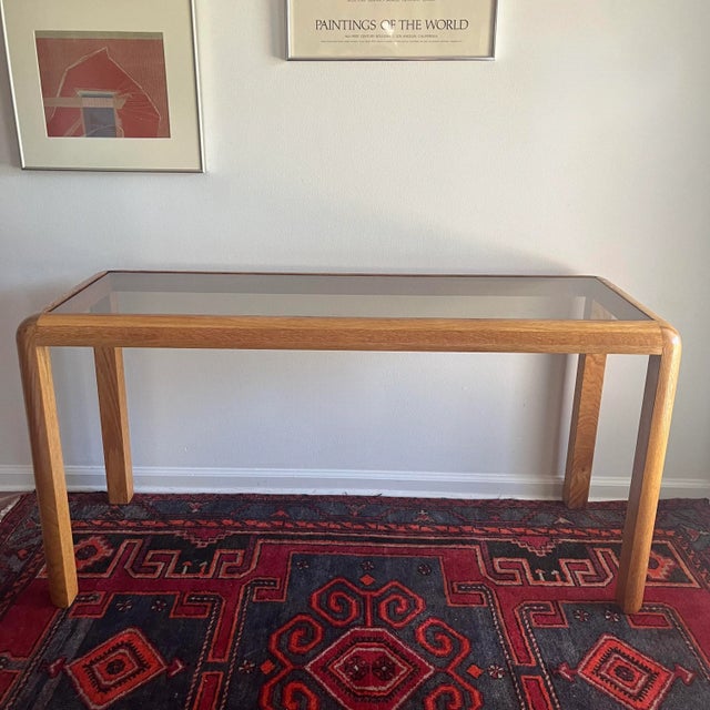Vintage wood console table with slightly tinted glass inset. Rounded edges parsons style. Measures: 54" x 20" x 27"H