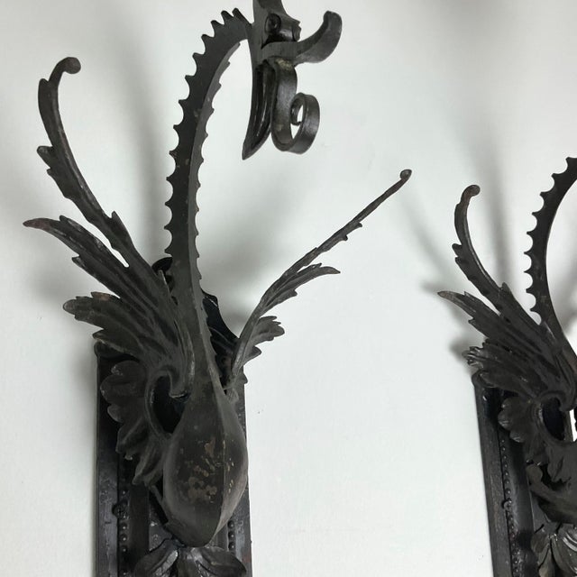 Add timeless elegance to any space with this beautiful pair of vintage wall sconces. Crafted from dark metal with...