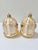 Pair of vintage German glass Christmas ornaments shaped like birdcages, each featuring a small colorful bird perched...