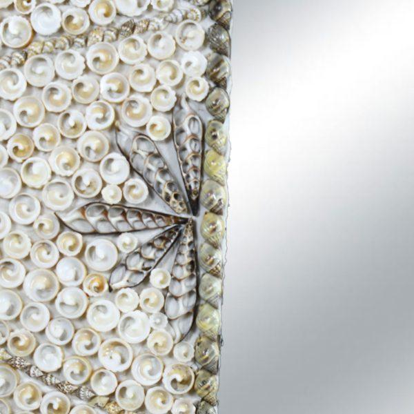A rectangular mirror whose wide frame is completely encrusted with natural shells, worked in swirling patterns with dark...