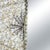 A rectangular mirror whose wide frame is completely encrusted with natural shells, worked in swirling patterns with dark...