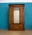 Late Victorian mahogany wardrobe with a mirrored centre door, moulded cornice and carved corner details, raised on a...