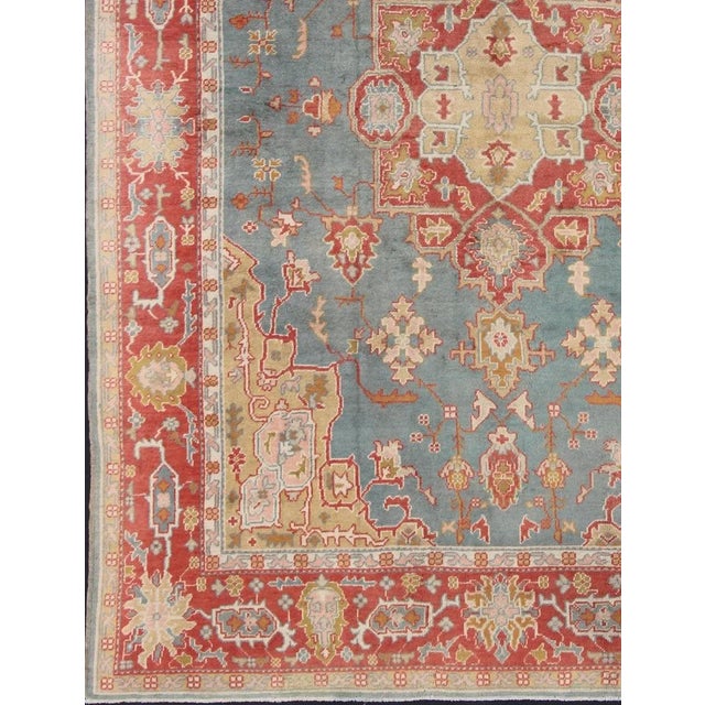 Antique Turkish Oushak Rug On A Blue Background and Orange-Red Color Border. Keivan Woven Arts / rug BHR-1, country of...