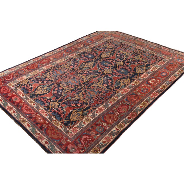 Hand knotted in wool originating circa 1900-1910, this 10x14 antique Persian rug connotes a traditional Bidjar rug design...