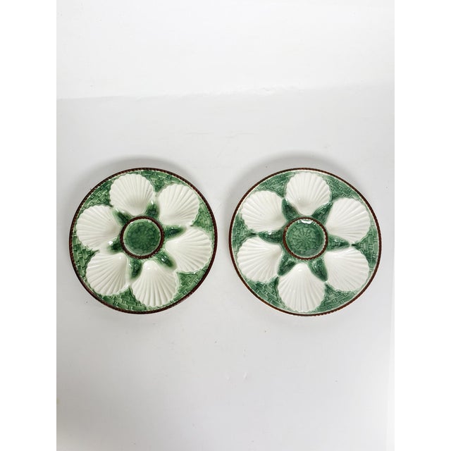 Charming pair of French oyster plates in glazed ceramic, dating from the 1920s. Each plate features six shell-shaped wells...