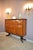 A large Italian bar cabinet attributed to Paolo Buffa, dating to the 1940s. The symmetrical case is executed in richly...