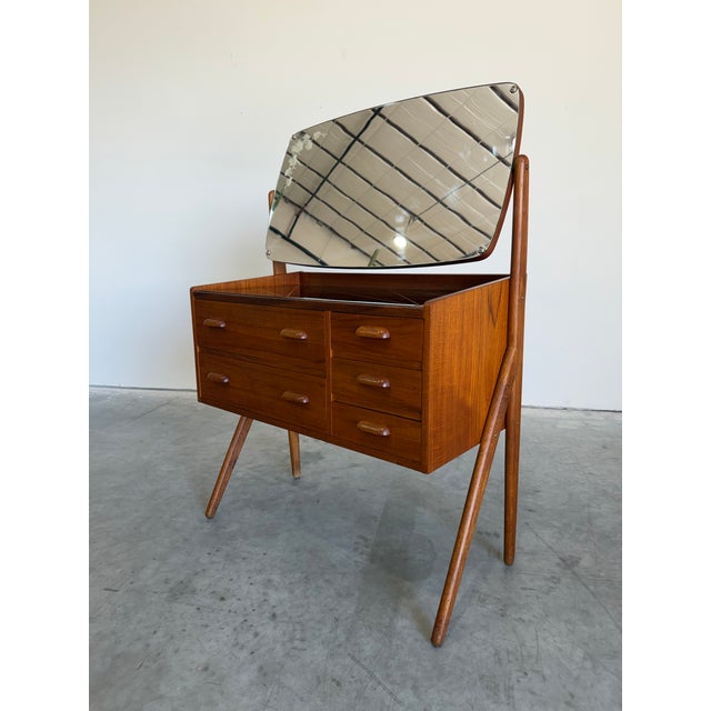 Petite Danish Teak Dressing Table Vanity. Beautiful sculptural legs, 5 drawers and black glass reverse painted top....