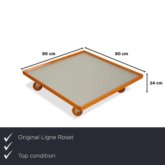 The Ligne Roset Parallel coffee table features a solid wood frame and an aluminum surface. The casters make the coffee...