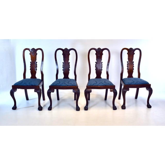 Set of four English Mahogany Queen Anne Dining Chairs with hand carvings to the splats, legs & ball with claw feet. The...
