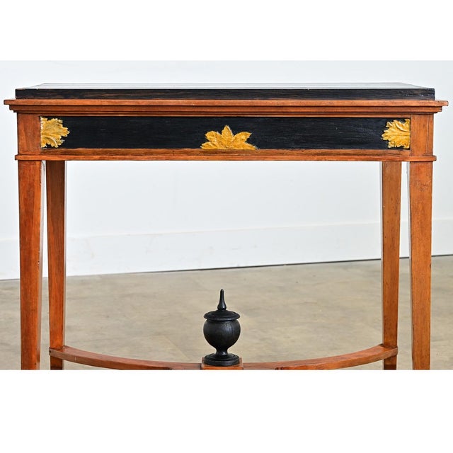 Swedish, late Gustavian period ebonized pine center table known as a “salongsbord” that integrates angular, curvilinear,...