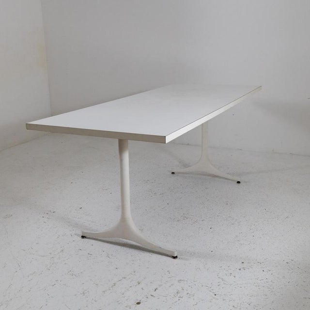 Description Rectangular table designed by George Nelson and produced by Herman Miller. The top is made of white laminate...