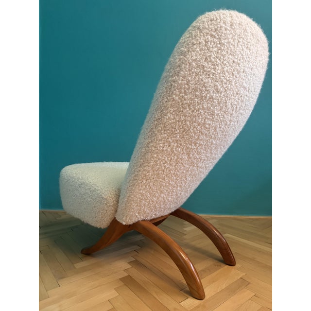 Completely restored and reupholstered in Dedar Alpaca Bouclé. Interior rebuilt with new coil springs. The cherry wood...