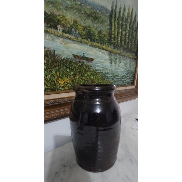 This antique stoneware crock was crafted by the Donaghho Company in Parkersburg, WV, during the 1800s. It features a wax...