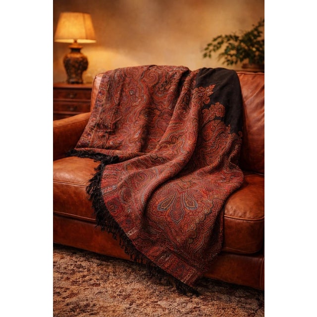 Large antique paisley shawl in the classic Kashmir style, featuring intricate boteh motifs in rich reds, rust, and...