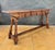 Spanish Renaissance Revival console table crafted in solid wood, mid-20th century. The piece features a thick plank-style...
