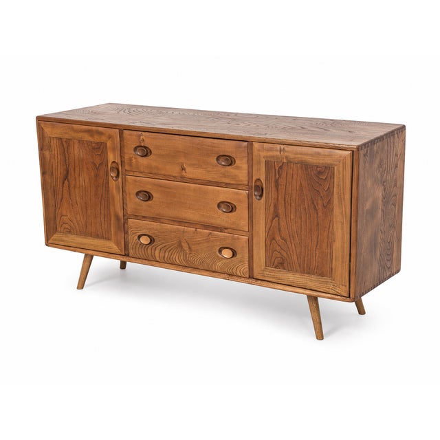 A beautifully and extensively restored 1970s Ercol solid elm sideboard, combining the distinctive craftsmanship of classic...
