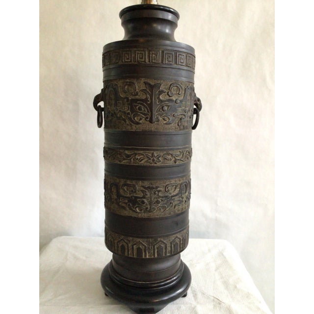 1940s Metal Table Lamp James Mont Style With Ring Handles and Greek Key Motif Mounted on wood base Embossed patterning...